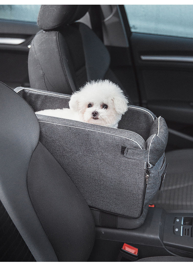 The Road Nest fitted between the front seats with a small white dog inside
