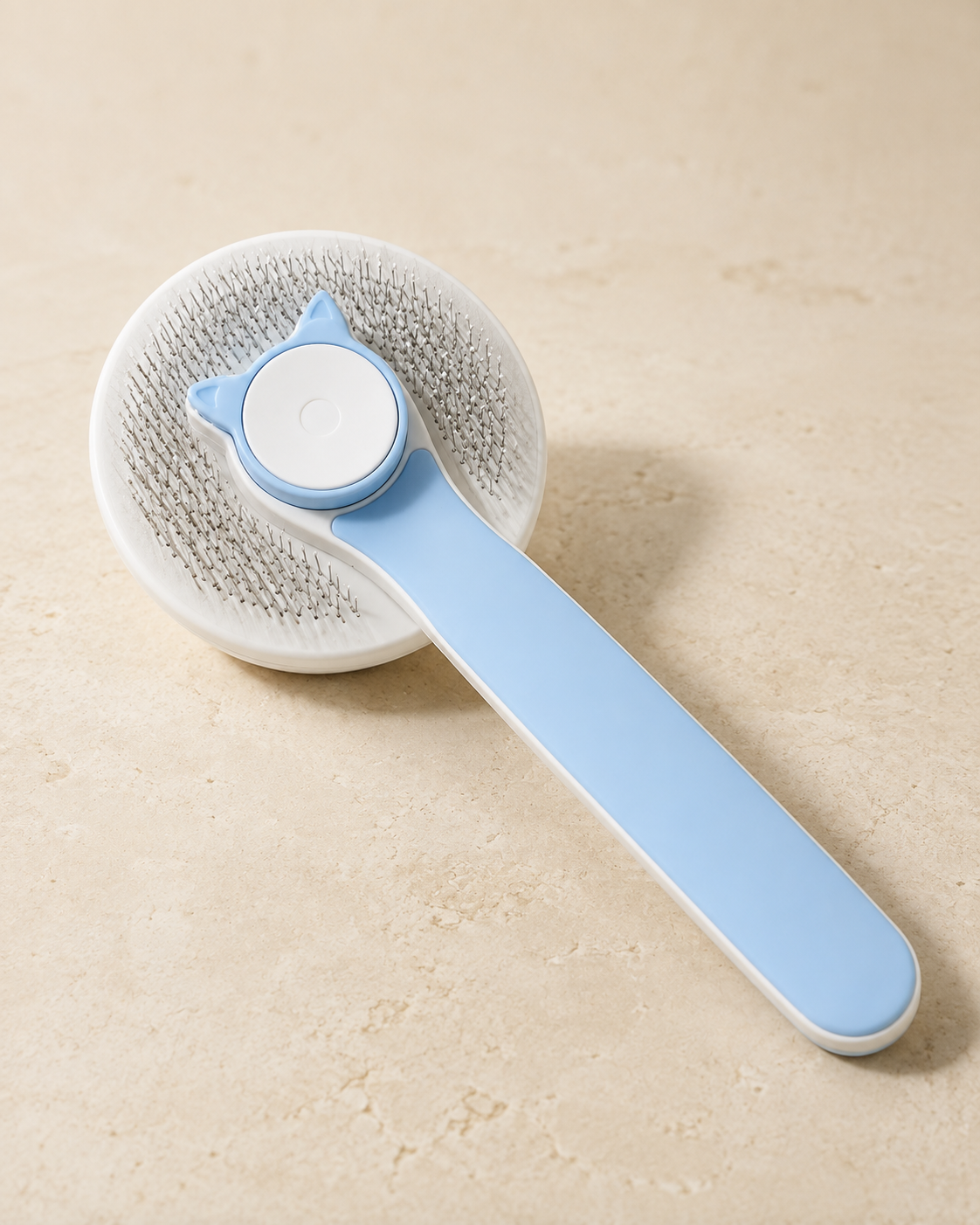 Coastal Blue Coat Brush, premium side angle showing self-cleaning button and metal pins