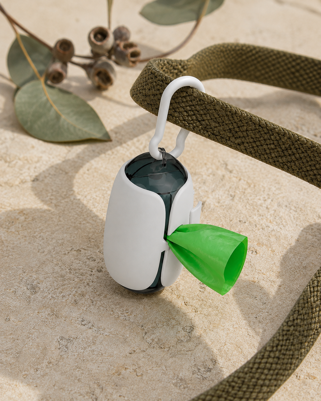 Field Walk Bag Holder attached to a leash with a green bag dispensing through the side slot