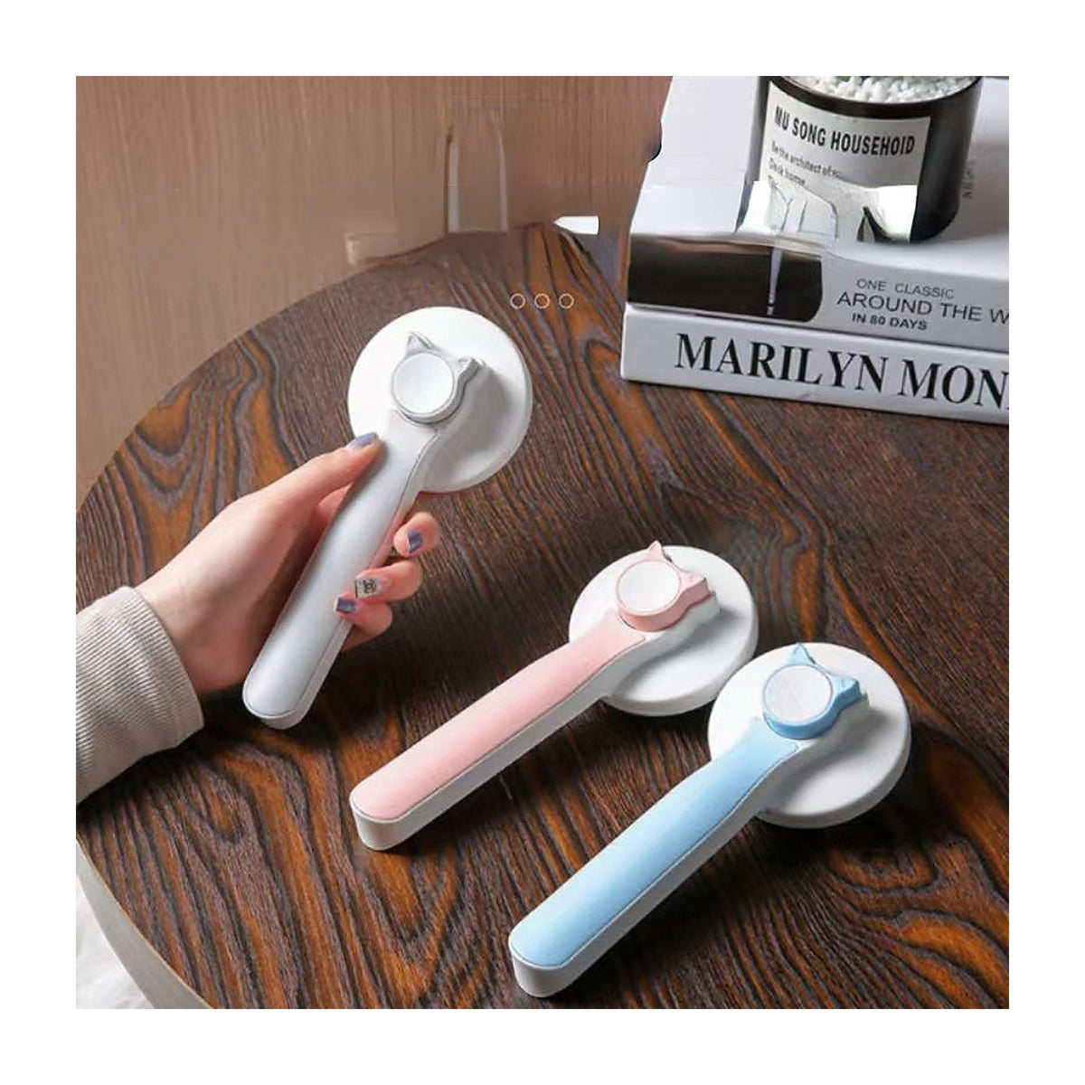 The Coat Brush shown in blue, coral and grey handle colourways