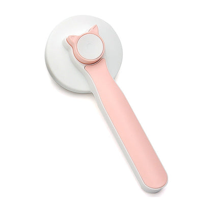 The Coat Brush self-cleaning slicker with a pink handle, seen from the front