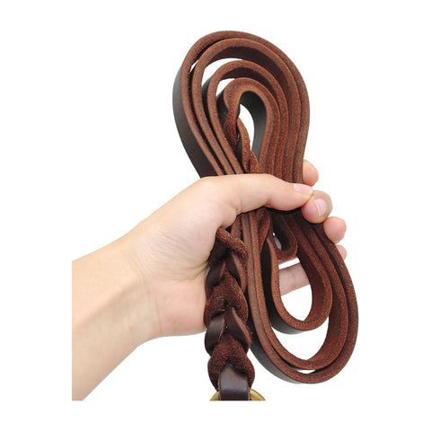 The Heritage Lead braided leather dog lead held coiled in a hand