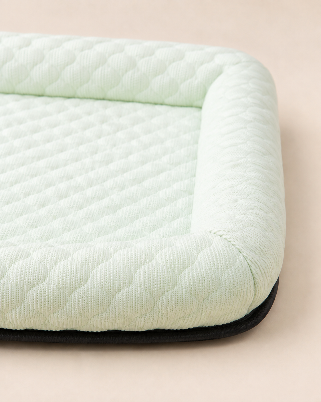 Green Summer Rest Mat close-up showing breathable knit, padded edge and black base